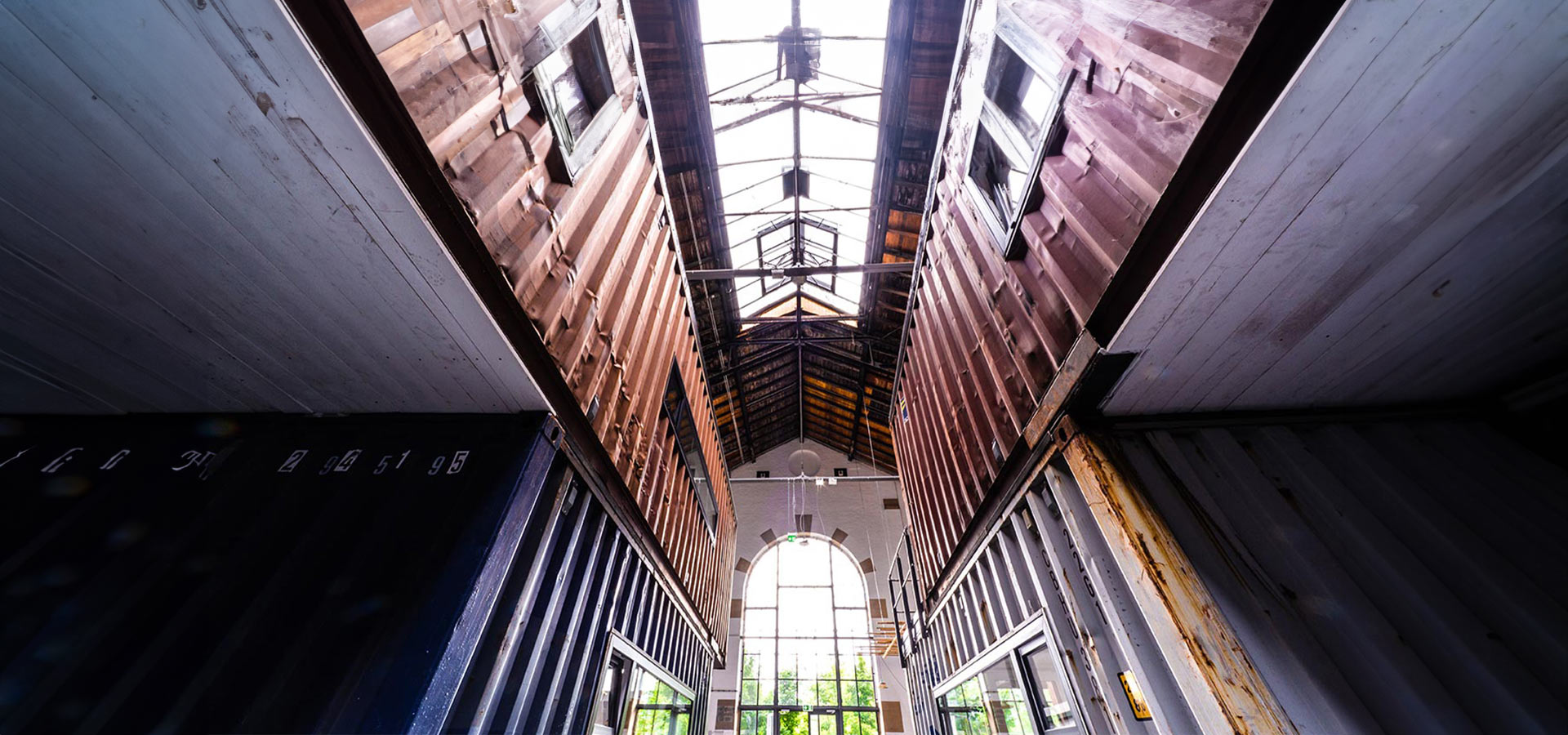 Aufnahme verschiedener Hafencontainer in einer alten Lockhalle aus der Froschperspektive