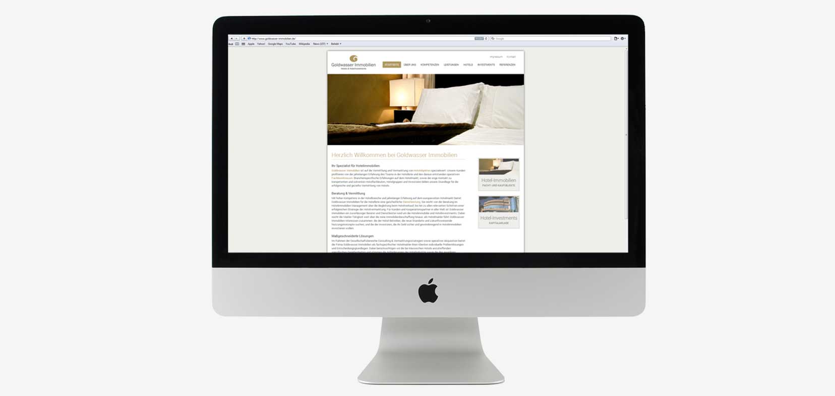 Ansicht einer Unterseiten der Webseite von Goldwasser Immobilien auf einem MacBook vor grauem Hintergrund