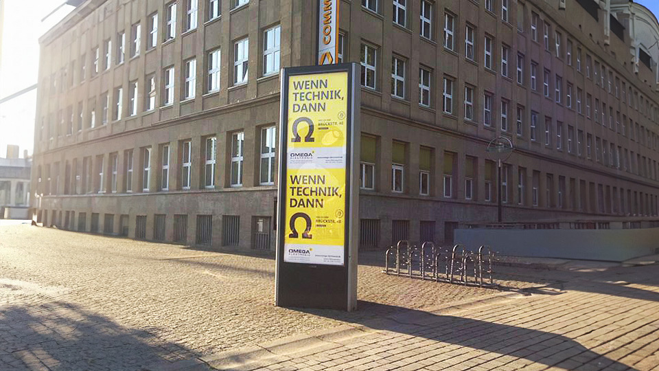 Ansicht Citylight von Omega Electronics neben einem großen Bürogebäude in der Innenstadt